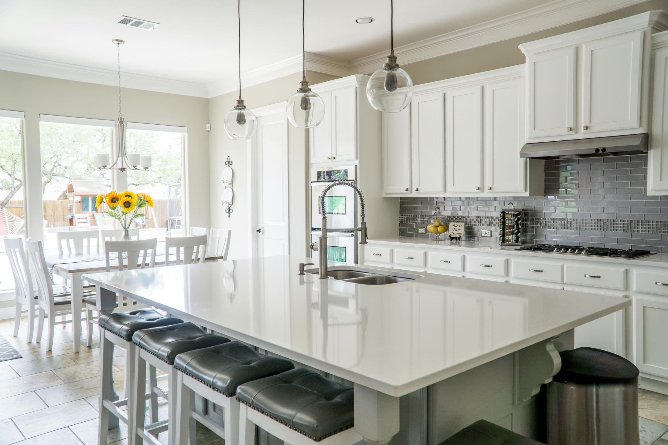 Bright kitchen with white cabinets and stone countertops