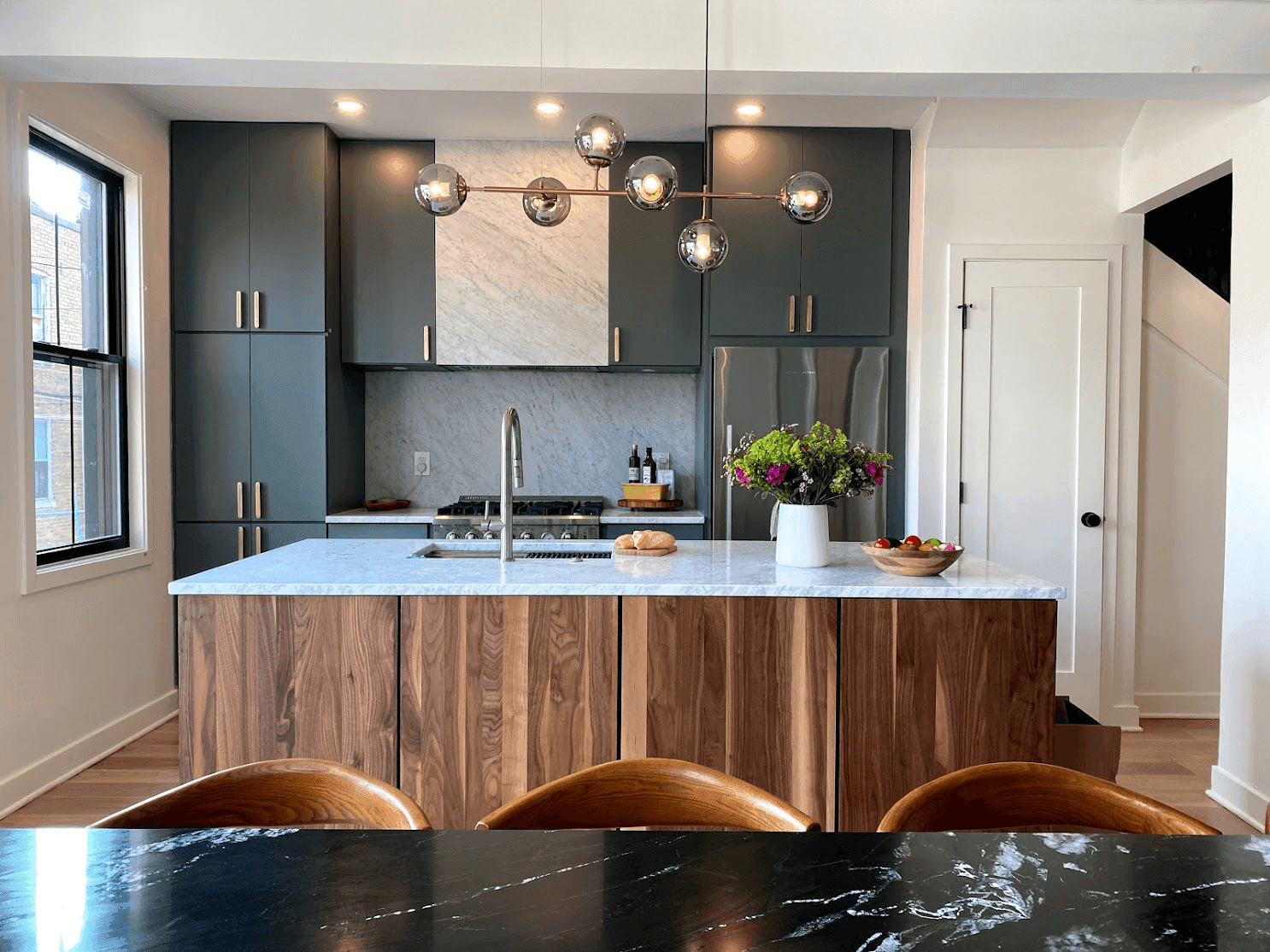 Modern two-tone kitchen with white shaker cabinets and a contrasting island