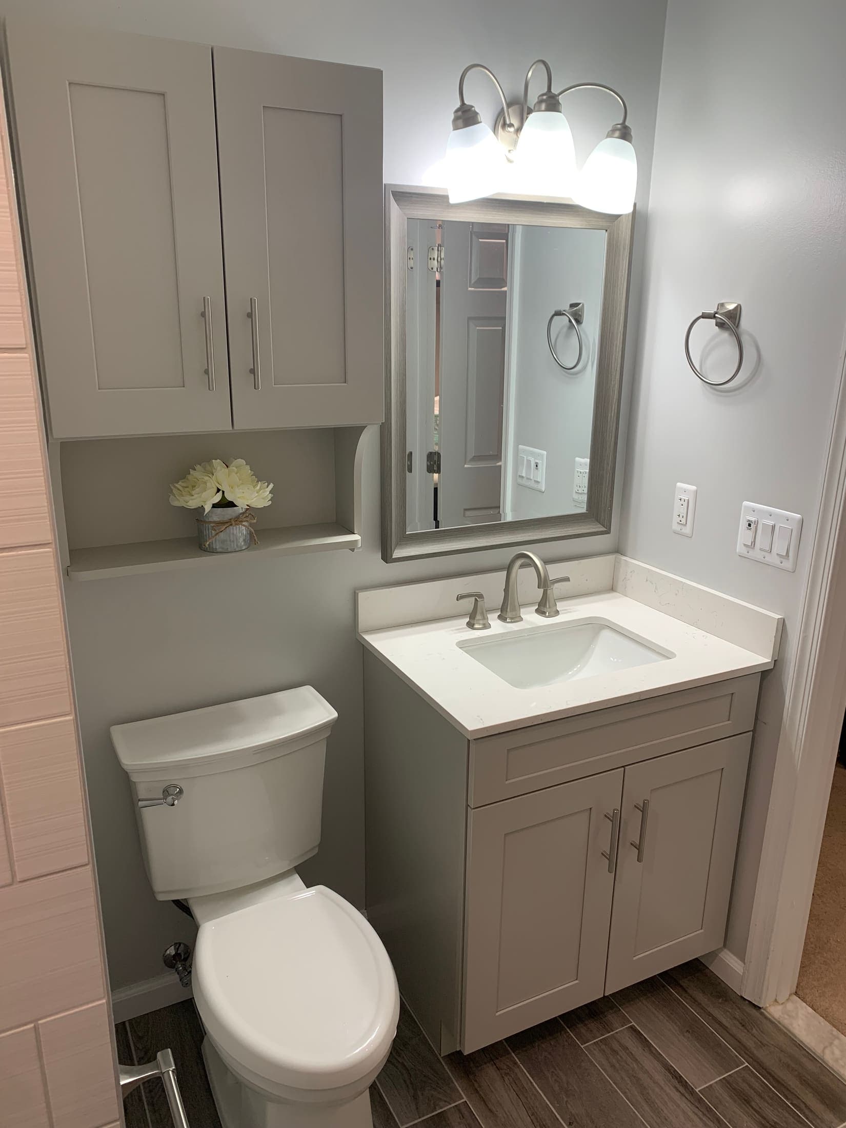 Gray shaker bathroom vanity with white countertop