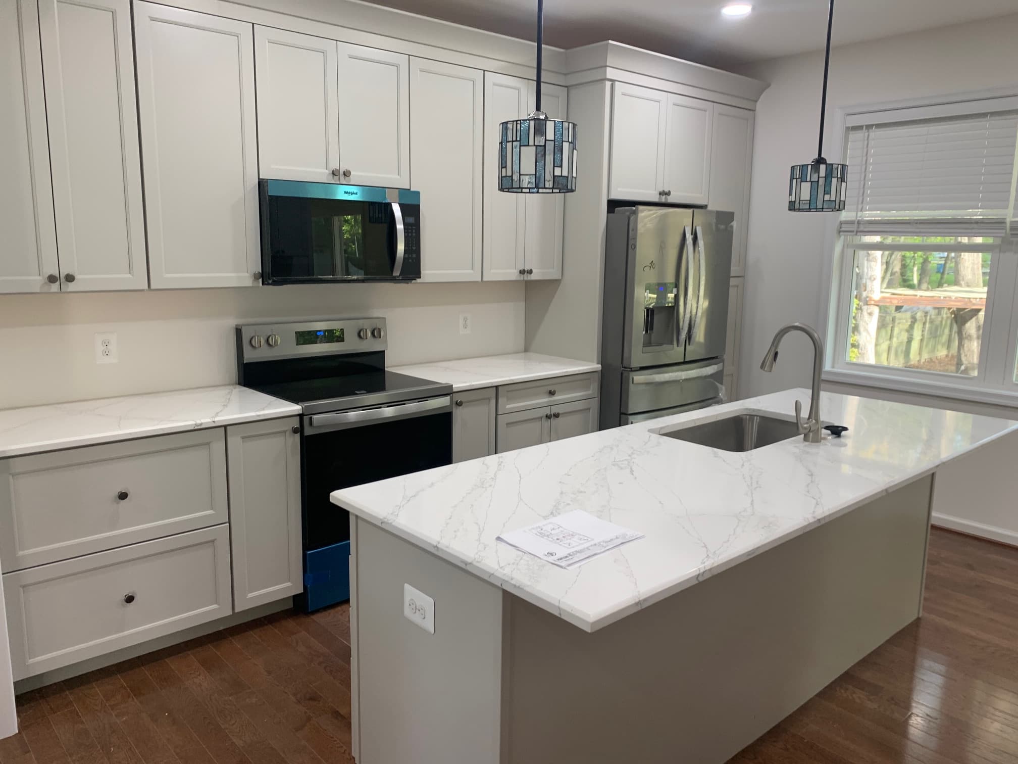 White shaker kitchen with a marble-topped island