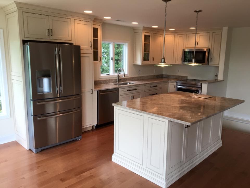 White shaker kitchen with a butcher block island top